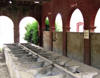 silent un-used washhouse under arched roof